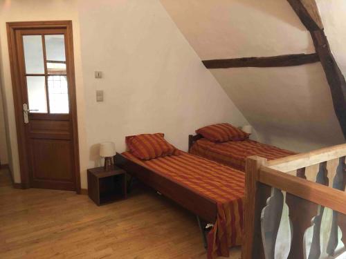 a bedroom with two beds and a staircase at Renaissance manor La Vieille Brèche in Parçay-sur-Vienne