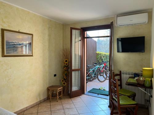 a room with a door open to a patio with bikes at Green House in Somma Lombardo