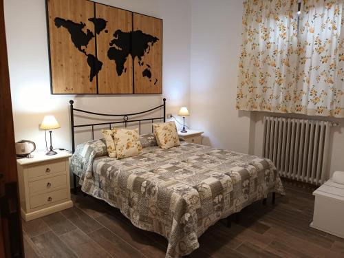 a bedroom with a bed with a map on the wall at B&B La Locanda del Sorriso in Orte