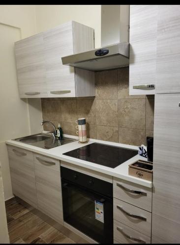 a kitchen with a sink and a stove at Dolce Dormire in Vigevano