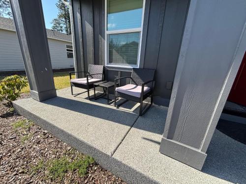 two chairs and a table on the porch of a house at Beautiful and amazing community in Graham