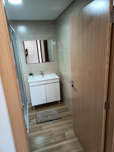 a bathroom with a sink and a mirror at Casa de baixo studios in Arouca