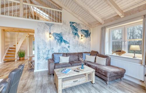 a living room with a couch and a table at 2 Bedroom Amazing Home In Dagebüll in Dagebüll