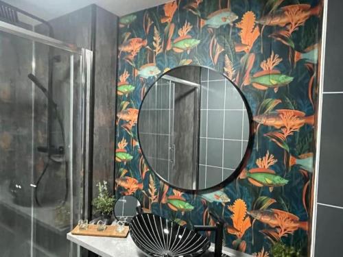 a bathroom with a large mirror on a colorful wall at The Exclusive Jacuzzi Apartment with Fireplace & Parking in Birmingham