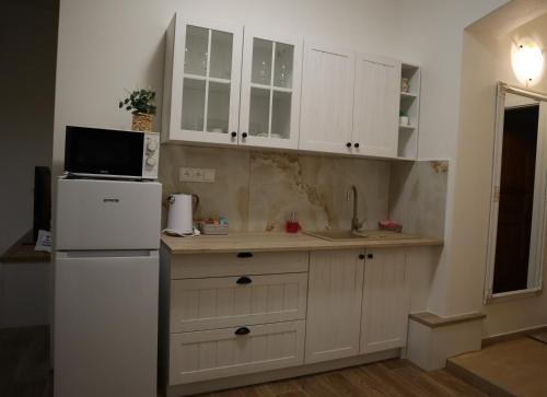 a kitchen with white cabinets and a white refrigerator at Olsinky in Ústí nad Labem