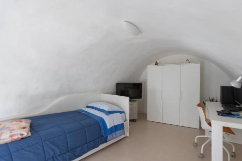 a bedroom with a bed and a desk with a computer at Giulia's House in Galatina