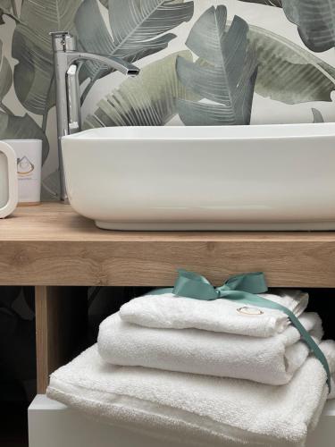 a bathroom with a sink and towels on a counter at Sweet home-Casa Di Bari in Turi