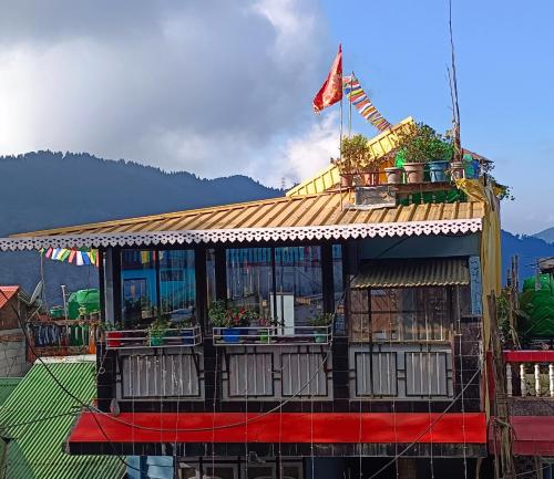 a building with a flag on top of it at Subba Homestay Sukhia Pokhari Ramjee Road in Sukhia Pokhari
