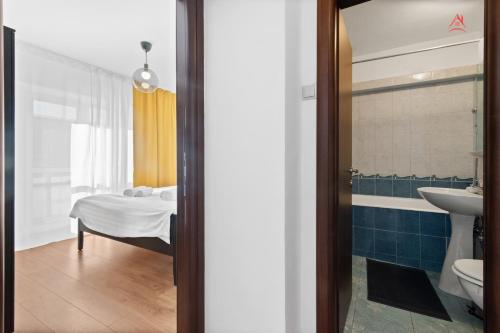 a bathroom with a sink and a toilet and a tub at Charm Apartment - Old Town in Bucharest