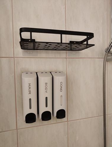 a group of three electric toothbrushes on a wall at Holiday house Panorama in Ozalj