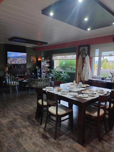 a dining room with a table and chairs at Posada Alma del Cerro in El Calafate