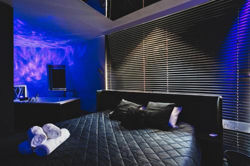 a bedroom with a bed with towels on it at Midnight Old Town in Bydgoszcz