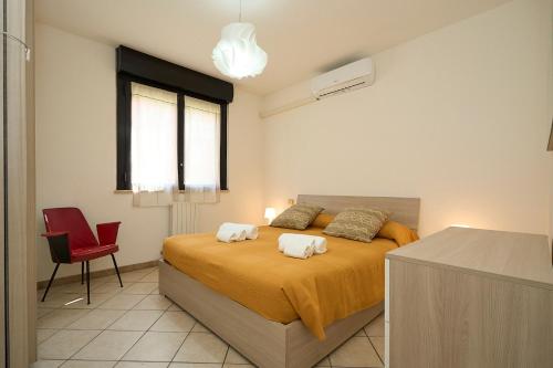 a bedroom with a bed with two towels on it at Humanitas House - 20 Minutes from DUOMO - Navigli in Milan