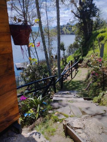a path next to a fence next to a lake at Cabaña Bella Vista in Pasto