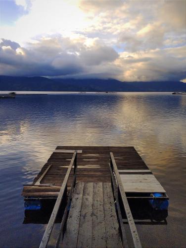 a wooden dock in the middle of a lake at Cabaña Bella Vista in Pasto