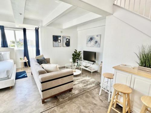 a living room with a couch and a table at Little Italy Modern Lofts in San Diego
