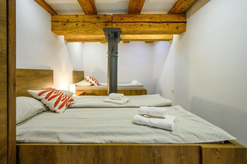 a room with a bed with two towels on it at The Comfortable Loft in Ljubljana