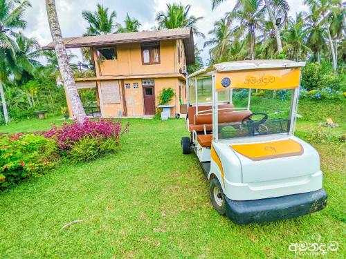 a golf cart parked in front of a house at Amandawa Eco in Gampaha