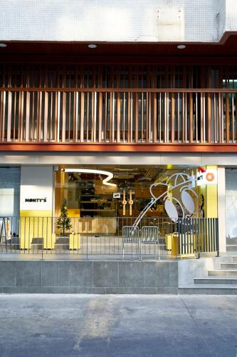 a store front with chairs in front of a building at Asia Hotel Bangkok in Bangkok