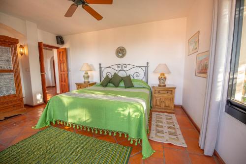 a bedroom with a bed with a green comforter at Casa Estrella de la Valenciana Hotel Boutique in Guanajuato