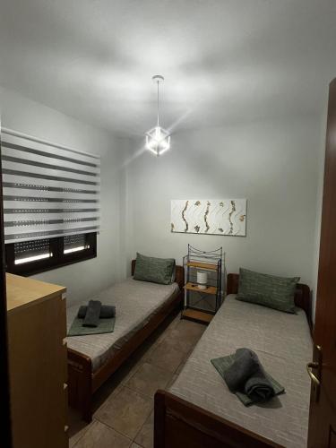 a living room with two beds and a ceiling at Veta's House in Olympiada