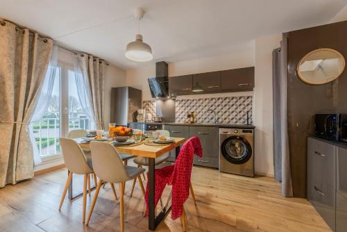 GuermantesAkropolis by Kleidos - Disney 15 mn - Beau duplex familiale pour 6 - 2 chambres- Parking Gratuit的配有桌椅的厨房和餐厅