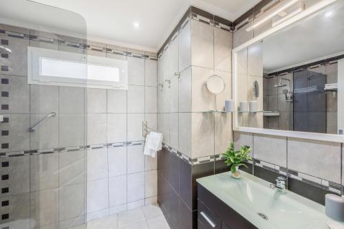 Un baño con lavabo y ducha en Sunsuites Collection - Las Flores, en San Bartolomé