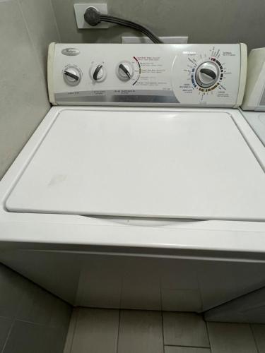 a close up of a washing machine in a bathroom at Lovely View Studio Building Heated Pool Gym Turco WIFI in Quito