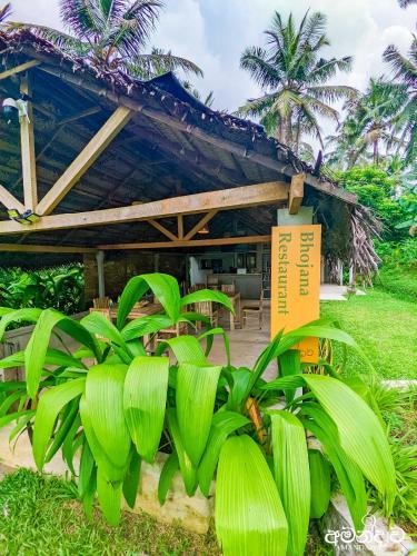 a building with green plants in front of it at Amandawa Eco in Gampaha
