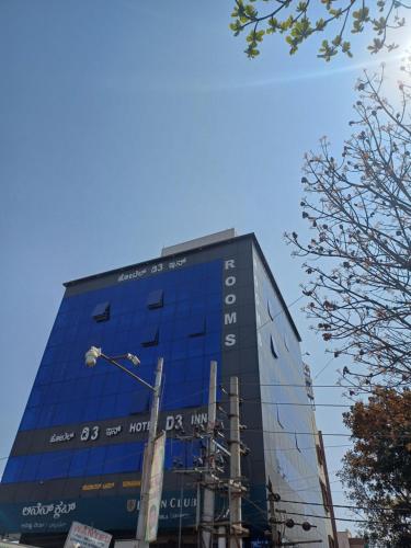 a tall blue building with a sign on it at Hotel D3 inn in Bengaluru