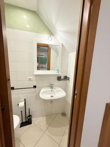 a small bathroom with a sink and a mirror at Maison Intarsio in Sorrento