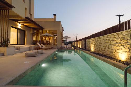 a swimming pool in the middle of a house at Atman Eco Lodge in Gliki