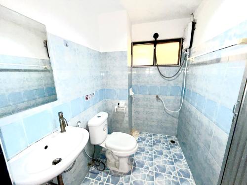 a bathroom with a toilet and a sink at Patong Canal Villa 211 in Patong Beach