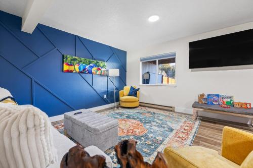 a living room with a blue accent wall at Hot Tub Hideout- Private & Downtown Access in Custer