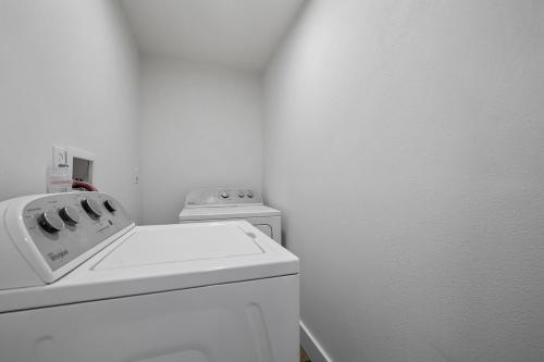 a white laundry room with a washer and dryer at Hot Tub Hideout- Private & Downtown Access in Custer