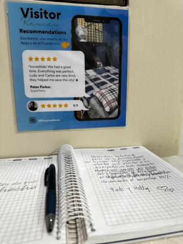 a sign on a wall with a pen and papers at Mini Suite en el centro de la ciudad in Macará