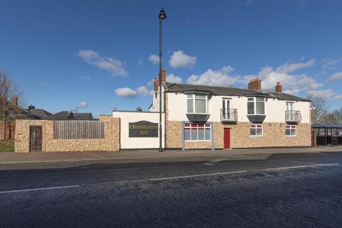 a brick building on the side of a street at The Crossroads Inn in Sacriston