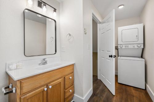 a bathroom with a sink and a refrigerator at The Paddle House - Hot Tub & Fire Pit Stay in Custer