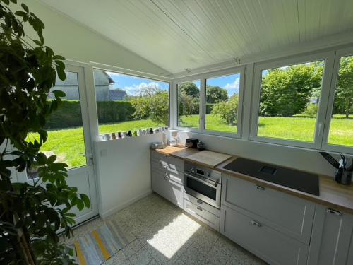 a kitchen with windows and a counter with a sink at Maison de Campagne pour 6 personnes Baromesnil in Baromesnil