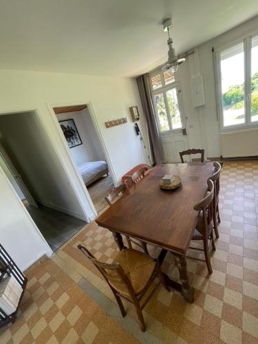 a dining room with a wooden table and chairs at Maison de Campagne pour 6 personnes Baromesnil in Baromesnil