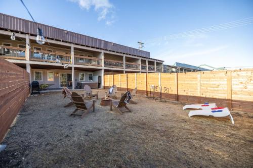 a group of chairs and tables in front of a building at Fireside Grove- Downtown Stay with Hot Tub in Custer