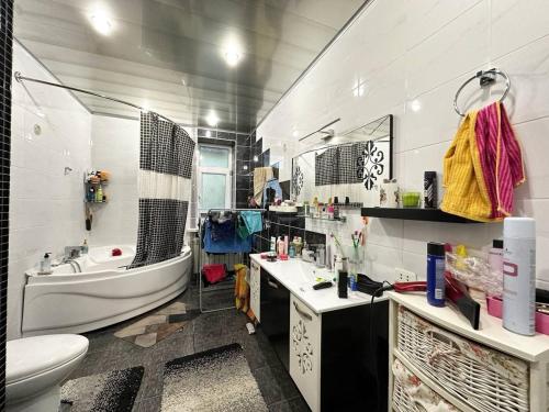 a bathroom with a tub and a sink and a toilet at Cozy Retreat in Green Dúbravka in Bratislava