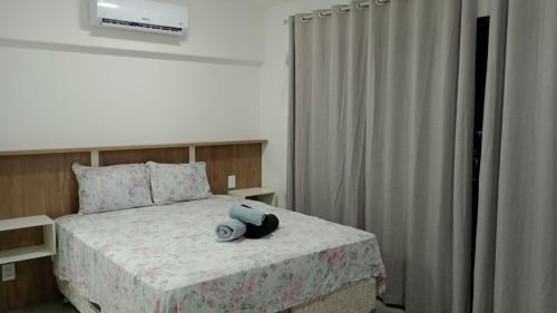 a bedroom with a bed with a hat on it at Studio 810 in Marília