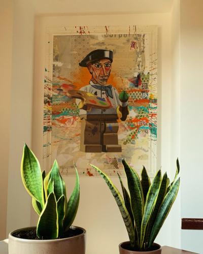 a painting of a soldier on a wall next to a plant at La Villa vacation home Lake Como in Como