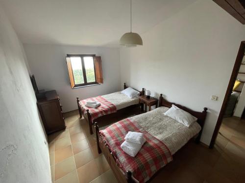 a room with two beds and a window at Casa da Foía in Monchique