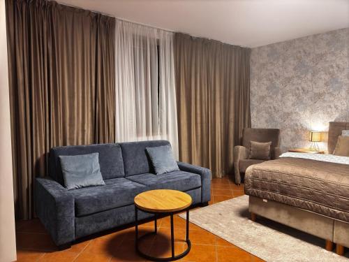 a living room with a couch and a bed at 3 bathrooms Apartman Mimi in Liptovský Mikuláš