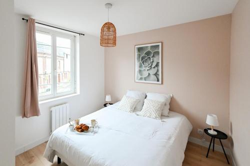 a bedroom with a white bed and a window at La Pinta - Fécamp in Fécamp