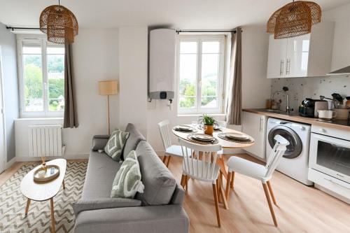 a living room with a couch and a table at La Pinta - Fécamp in Fécamp
