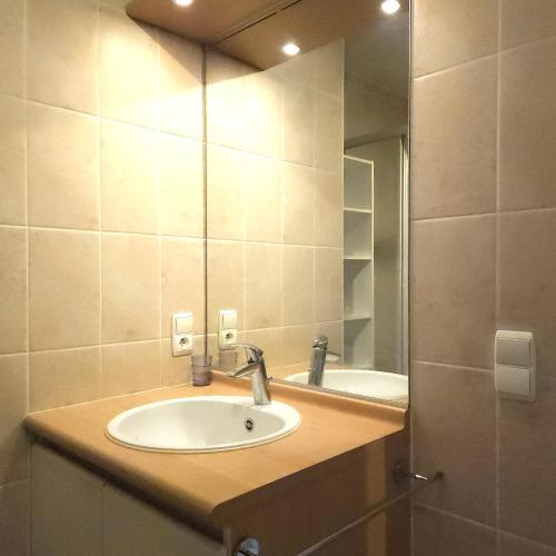 a bathroom with a sink and a mirror at Sun & Sea Blutsyde in Bredene