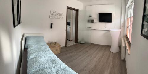 a bedroom with a bed and a television in it at Business HO 03 in Neckarsulm